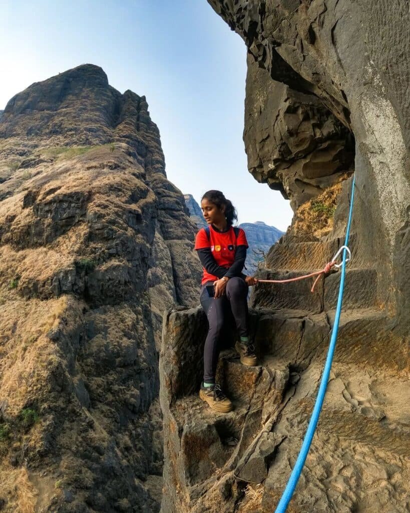 Trekker on top of bhairavgad with harness